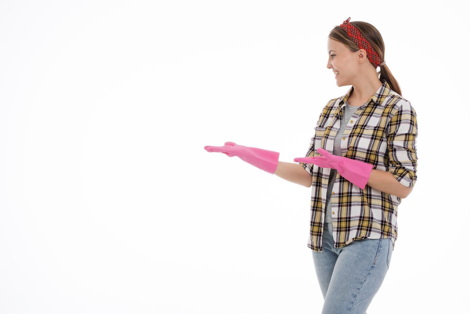 Smiling professional house cleaner in uniform